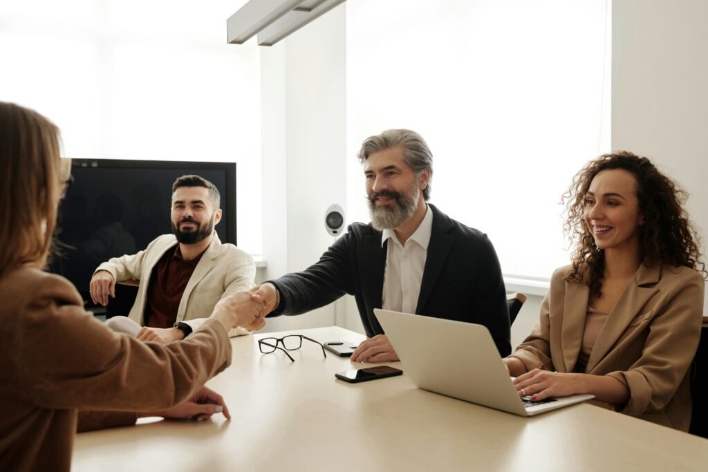 happy couple shaking hands in an office